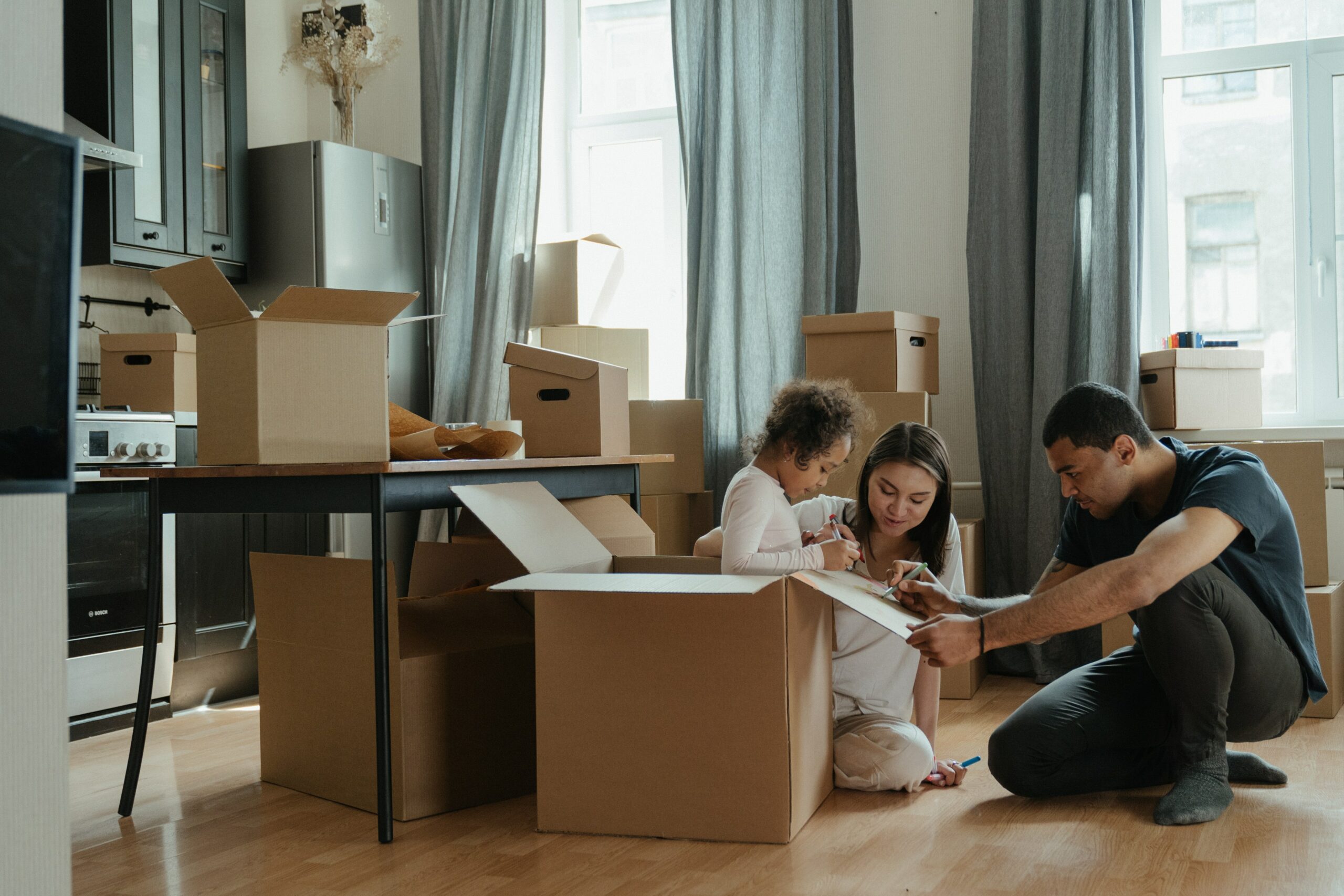 Family is packing boxes for their home relocation
